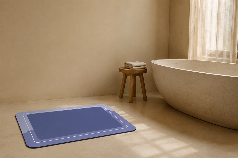 The bath mat on the floor of a calm bathroom beside a stone bathtub