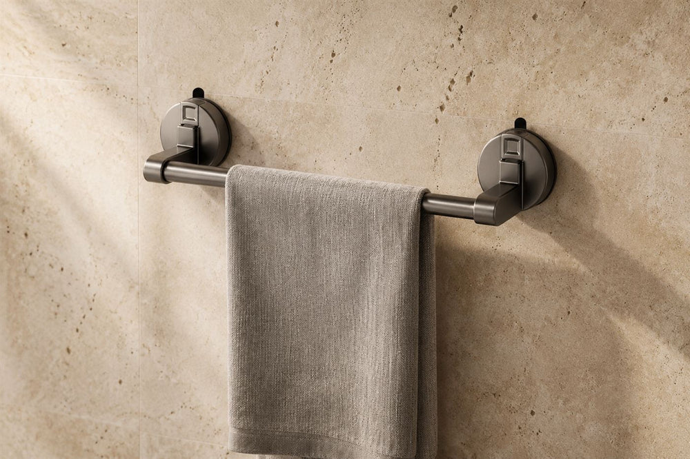 Maison Ivo gunmetal suction towel rail on a travertine wall with a linen towel
