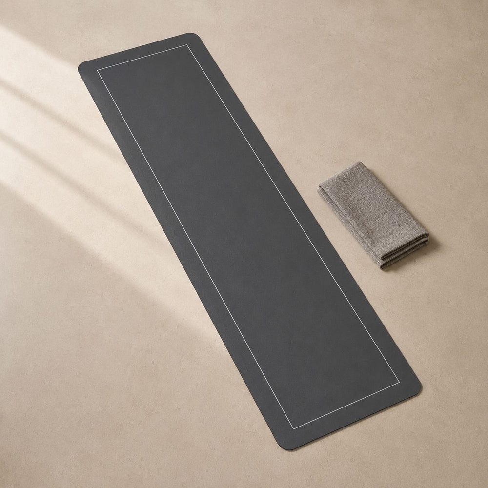 Top-down view of the charcoal quick-dry runner with a folded linen towel